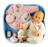 A cuddly baby doll with accessories:  - 50cm doll in a pink andamp; white baby grow with a bottle