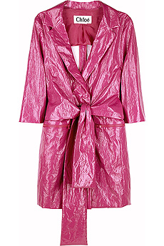 Pink vinyl raincoat with zip fastening pockets on front and a self-tie bow belt.