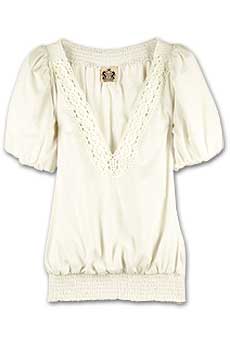 Cream cotton blouse with crochet trim and short puff sleeves.
