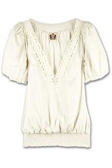 Cream cotton blouse with crochet trim and short puff sleeves.