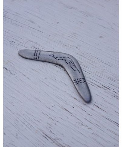Boomerang travel token with Return Safely message on reverse