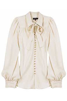 Cream silk shirt with tiny gold button fastenings on front and a self-tie bow at neck.