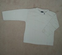 Dark beige top with navy "n" embroidered on the ne