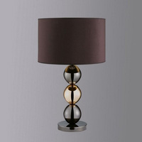 An elegant contemporary metal table lamp with polished brass and black chrome balls complete with ma