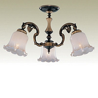 Solid antique brass fitting with delicate metal leaf design combined with cream glass with amber lip