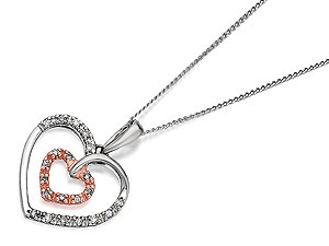 White diamonds each side of the 1.2cm outlined heart, with a delightful mini heart within it, surrounded by natural pink diamonds - lots of lovely symbolism - strung from an 18/46.5cm fine chain. From our exclusive One In A Million collection.