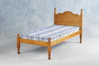This deep antique pine bed will be at home in any bedroom.  An elegantly shaped headboard enhances