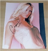 Superb colour photograph of the lovely Caprice signed in black pen. COA - 0700000012