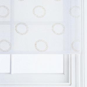 A white voile blind with a raised geometric circul