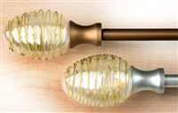 Contemporary metal curtain pole with clear swirl polyresin finials. Includes 20 curtain rings and