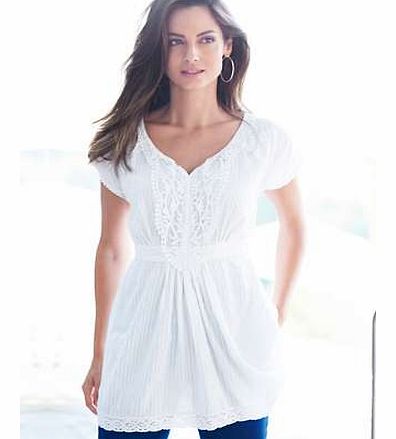 A cool and comfortable Summer tunic complete with crochet trim to front, sleeve and hem. The tie fastening back makes for a flattering shape. Tunic Features: Washable 100% Cotton voile Length approx. 75 cm (30 ins) This item is part of our exclusive 