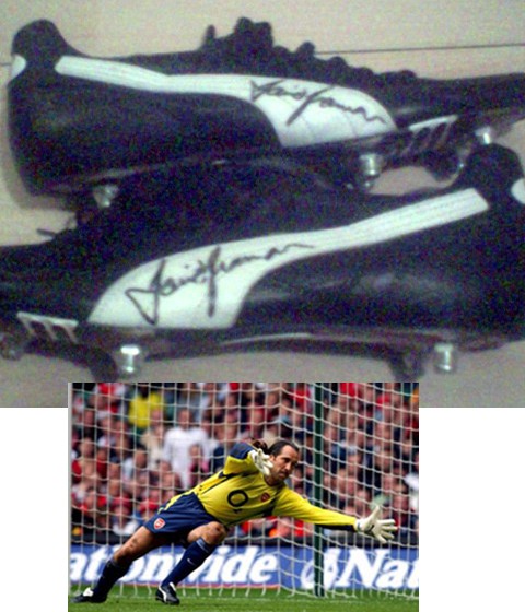 This is a pair of black and white puma studded football boot which were worn by Arsenal keeper
