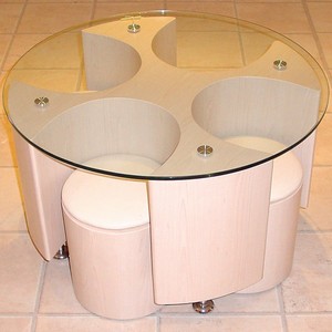 This organic design glass-top table comes in a beech veneer finish, and has four accompanying