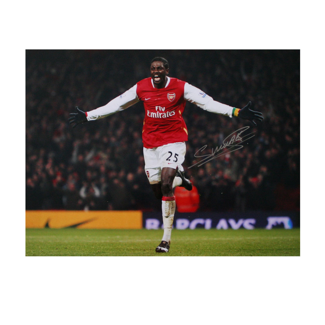 This photograph shows Emmanuel Adebayor with arms outstretched, passionately celebrating a goal for 