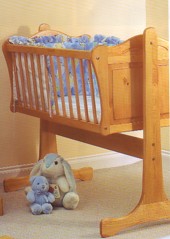 large crib made from solid pine wood. attractively engraved. rocks gently. has a locking mechanism