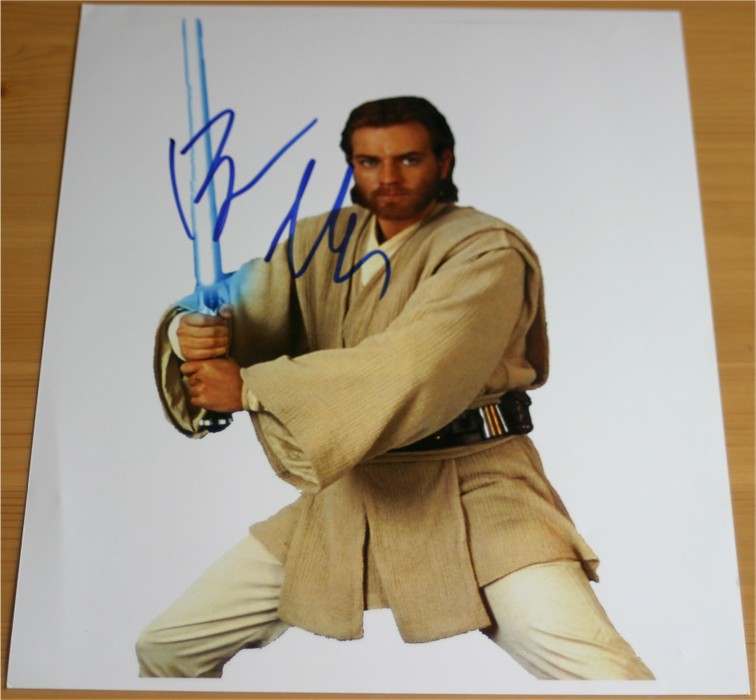 Quality colour photograph of the Star Wars cast which has been signed in blue pen by Ewan McGregor