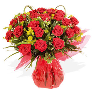 24 red roses HT with looped flexi grass palm varigated pitto hard ruscus and buplerum wrapped with c