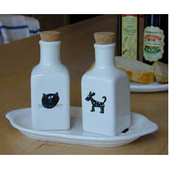 A glazed ceramic oil and vinegar set with cat and dog designs from Italy.
