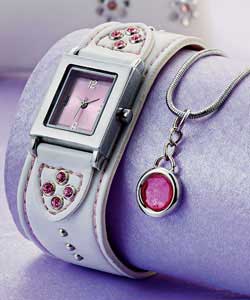 Pink dial. Square silver case.White strap with pink stones and silver studs. Matching pendant and pu