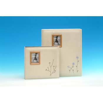 This linen covered album has a rich padding and features a small photo frame on the front cover for