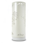 Stylish cream cylindrical shaped complete lamp with a unique floral lasercut design.