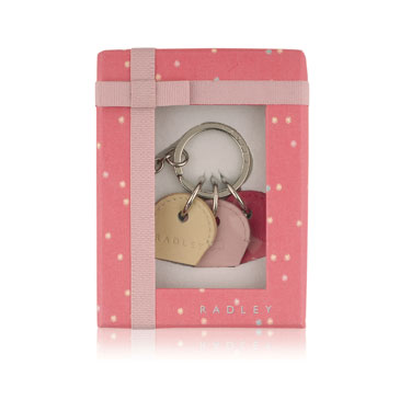 This colourful keyring features three leather key covers in yellow pink and red. This is adorable an
