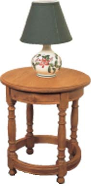 A beautiful round pine lamp table with 4 turned legs within ring design. With one drawer  this is