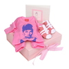 The Little Diva Gift Set includes an Audrey pink rompersuit, double photo frame and pink trainer sho