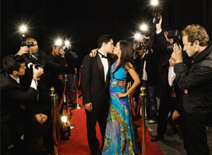 The flash of the paparazzis cameras, rubbing shoulders with 