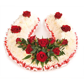 A traditional massed Chaplet with a spray of velvety Red Roses.