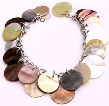This simply stunning bracelet compromises a silver chain decorated with shell discs in an array of