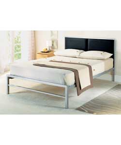 Double metal bedstead with faux leather luxury upholstered headboard. Sprung mattress.Overall size