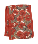 This long pure silk scarf is decorated with a vivid poppy print with a brick red border. 100 silk.