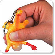 Lightly squeeze the rubber belly of the rather disturbing miniature chicken (9 x 5)cm and an `egg` w