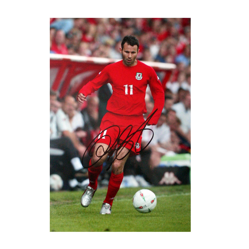 This signed Ryan Giggs photograph shows Giggs in action for Wales. After 64 caps for Wales, Giggs is