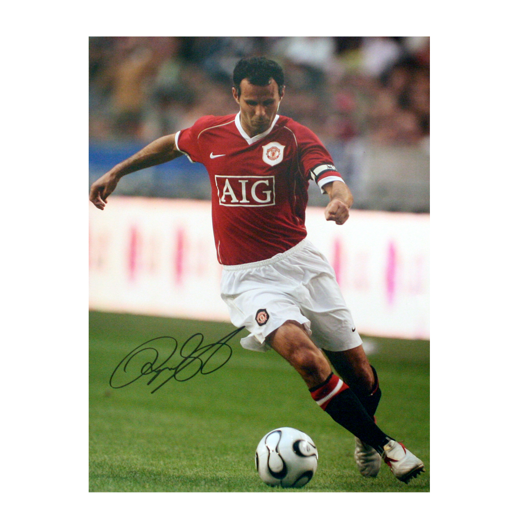 This signed Ryan Giggs photograph shows Giggs in action for Manchester United.The print is 16` x 12`