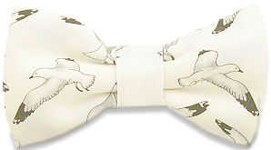A lovely pre-tied bow tie with seagulls flying all over on a white background.