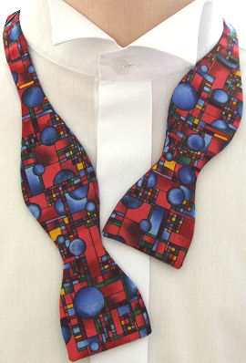 A lovely abstract bow tie with various circles and squares on a reddish background.