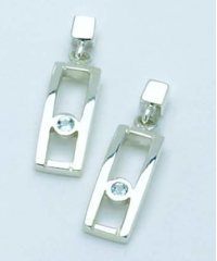 Sterling silver earrings each set with a single blue topaz