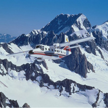 Soar over a snowy wonderland filled with towering icy peaks, azure blue lakes and sparkling glaciers