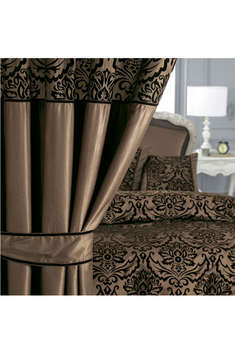 With tie backs. Give your bedroom a touch of luxury with this stunning traditional flock on faux sil