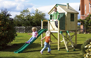 A wooden outdoor play house on stilts