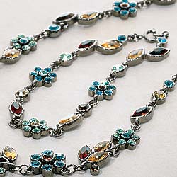 Multi-coloured glass crystal flowers on ruthineum-plated chains, inspired by the work of Art