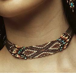 Inspired by the jewellery created by Zulu women. The woven coral, turquoise, wood and glass beads