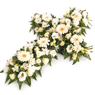 An elegant open cross tribute in white with lush foliage.