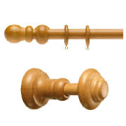 This set comprises a curtain pole and a pair of matching holdbacks, both finished with a classic