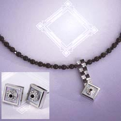 These rhodium-plated pieces with faux jet and crystal resemble fashionable Art Deco originals. The